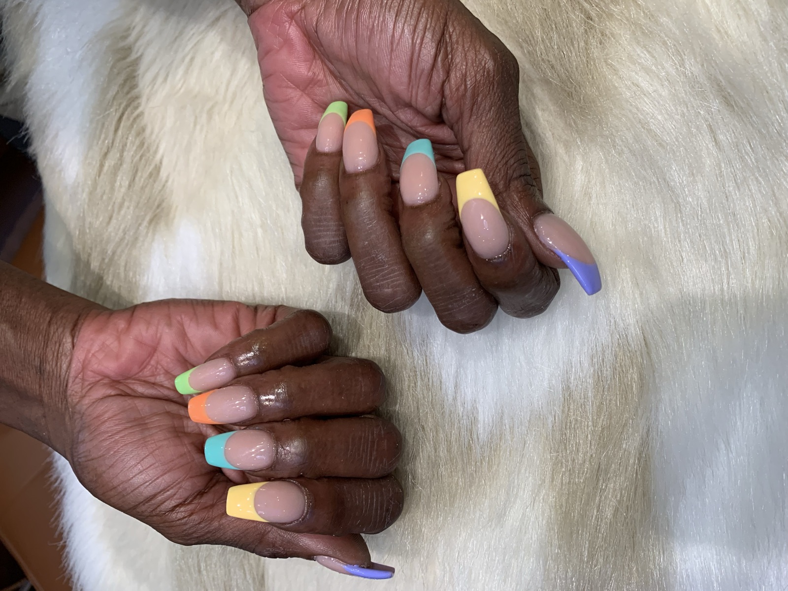 Square nails with a nude base and colorful French tips