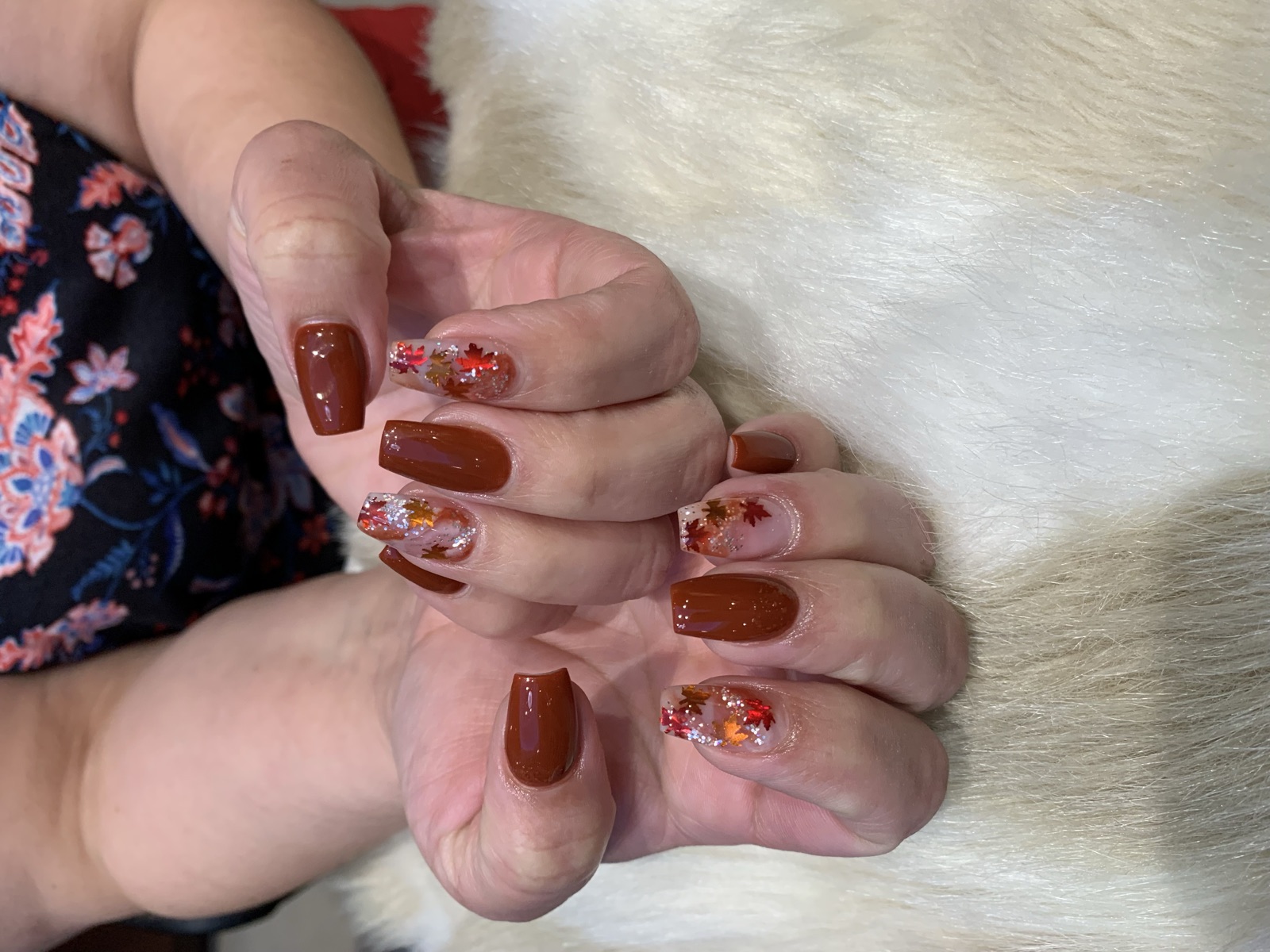 Coffin nails with burnt orange polish and metallic maple leaf accents