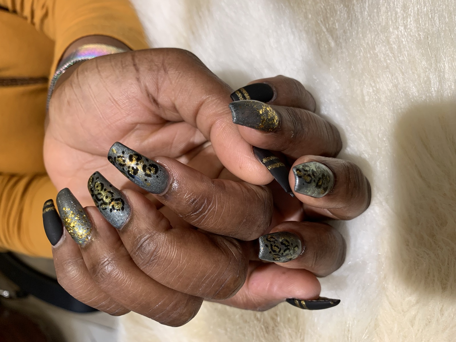 Coffin nails with gunmetal leopard print, gold glitter, and matte black stripes