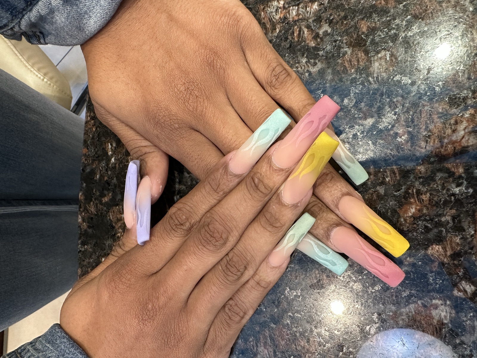 Long square nails with pastel ombré tips and raised flame designs