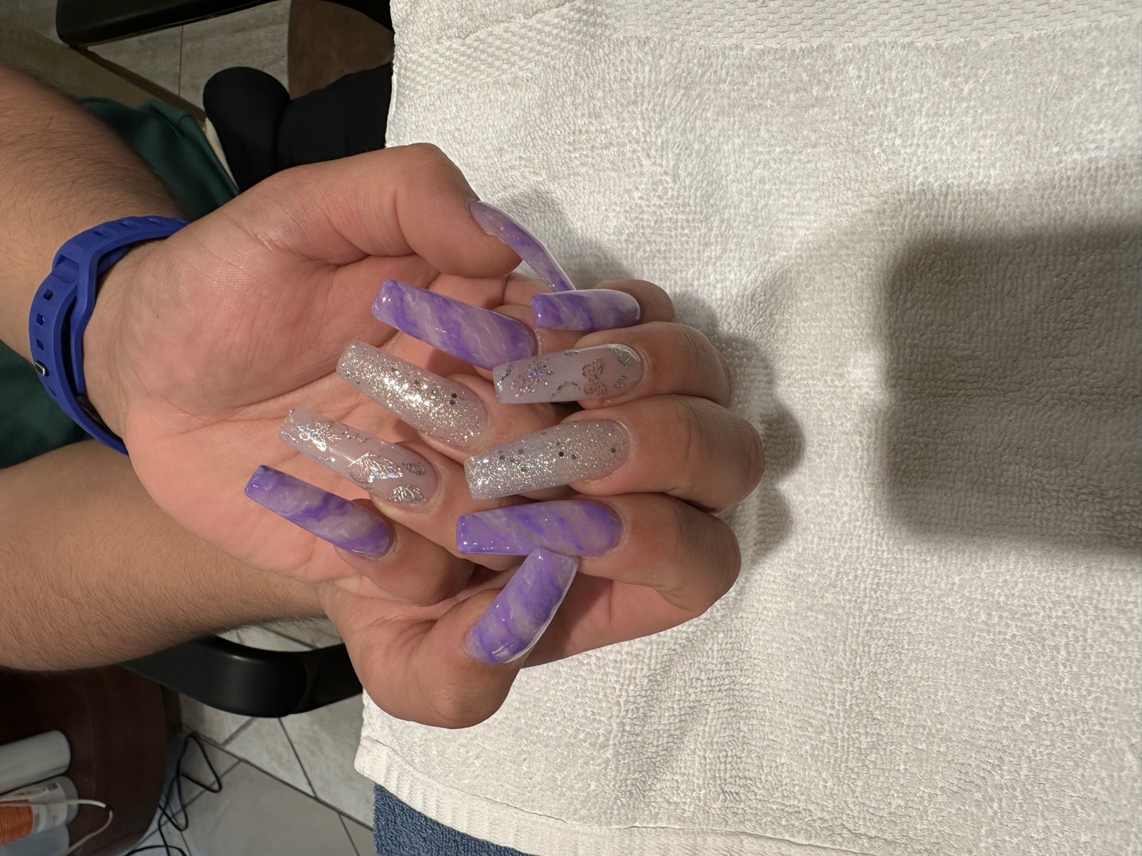 Coffin nails with lavender marble, silver glitter, and butterfly details