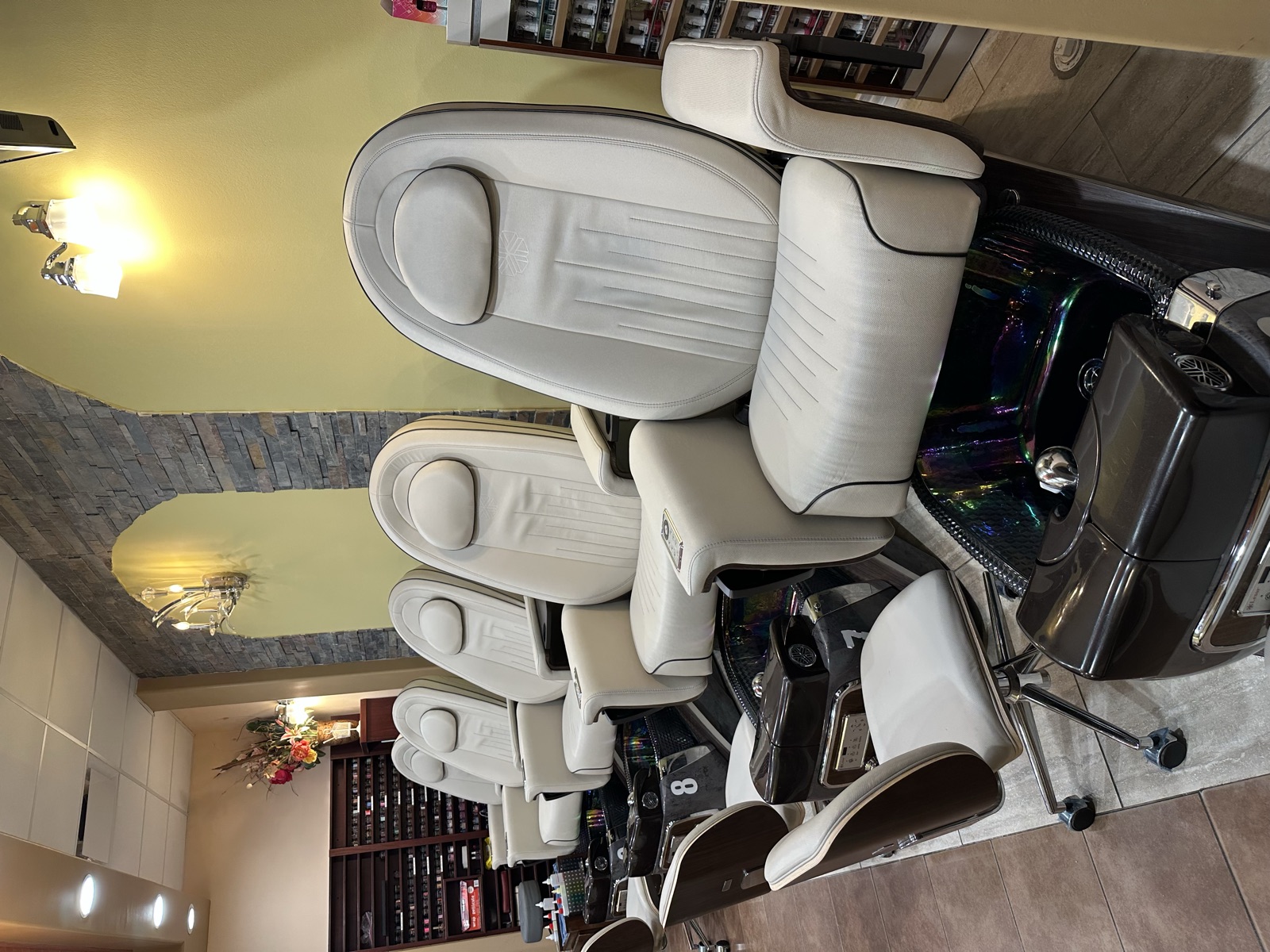 Pedicure chairs and polish wall inside Arboretum Nails & Spa
