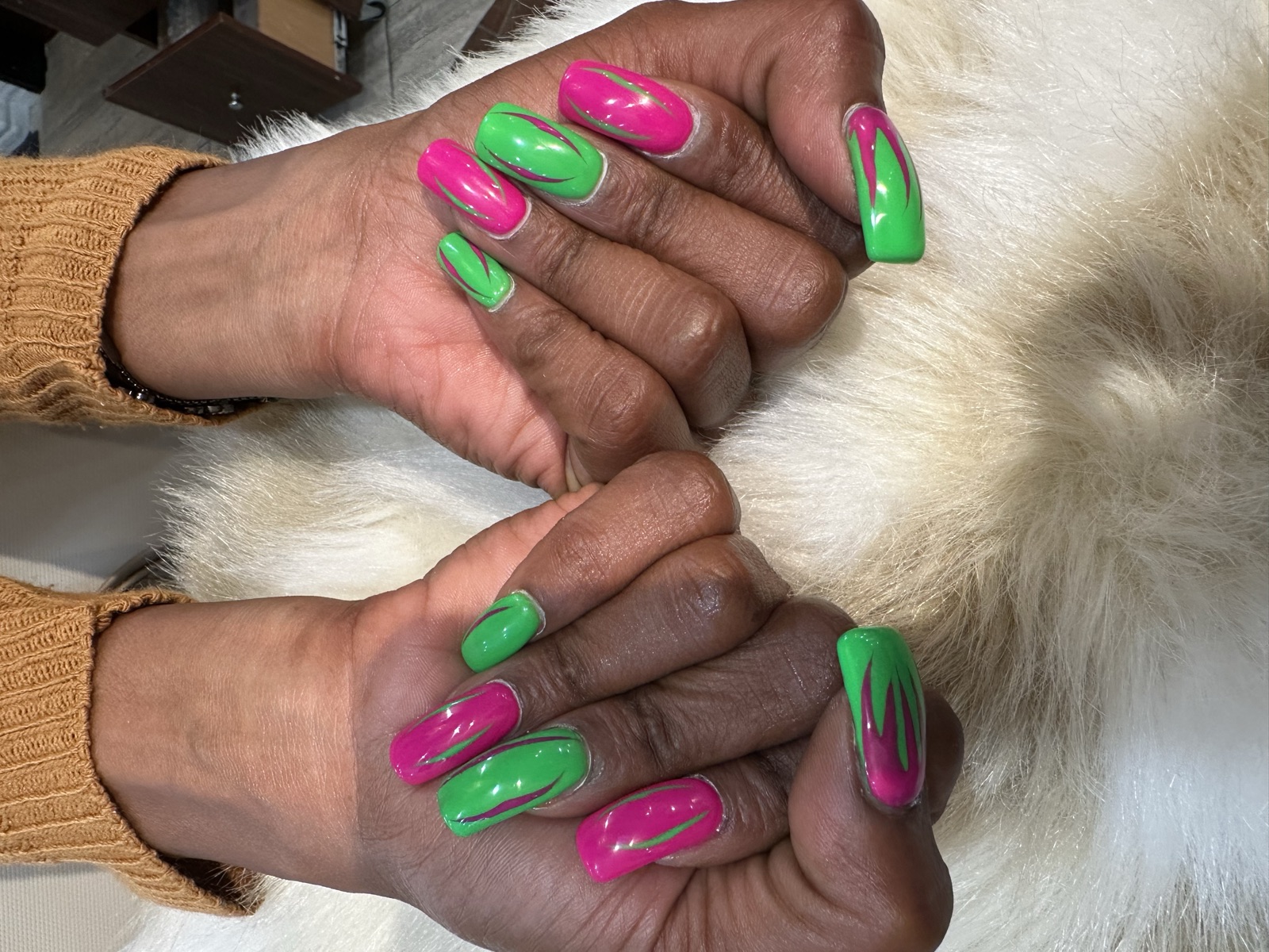 Long square nails with wavy lime green and magenta flame designs