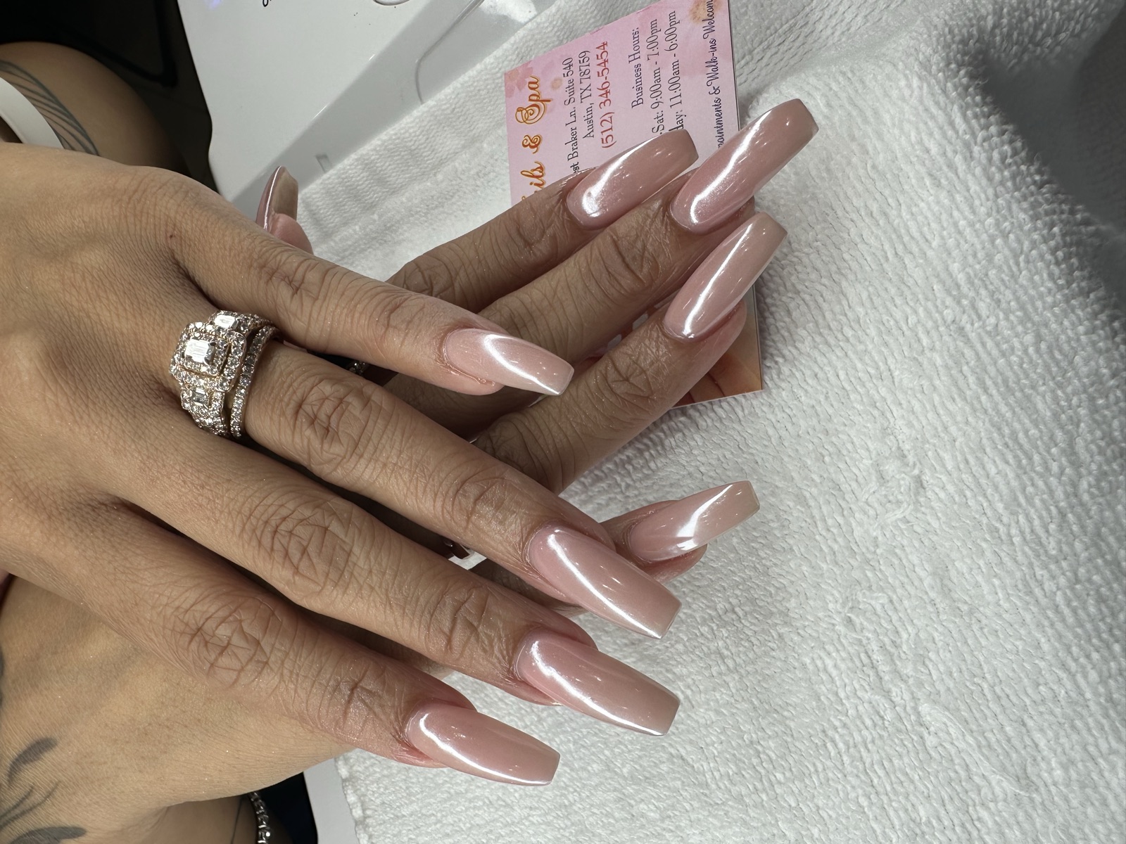 Long coffin nails with a glossy pearlescent pink chrome finish