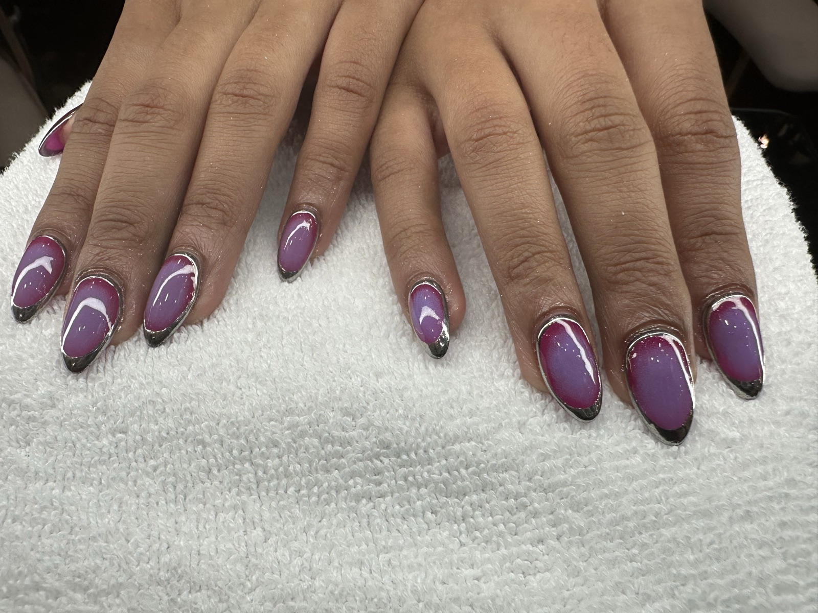 Almond nails in glossy purple with metallic silver chrome tips