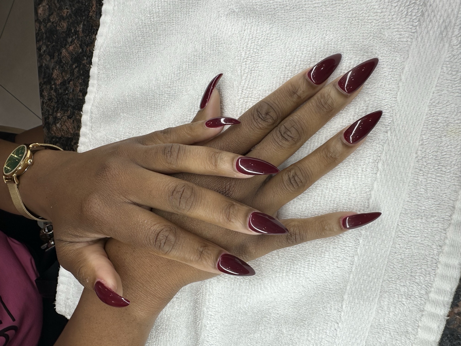 Long stiletto nails in glossy deep burgundy polish