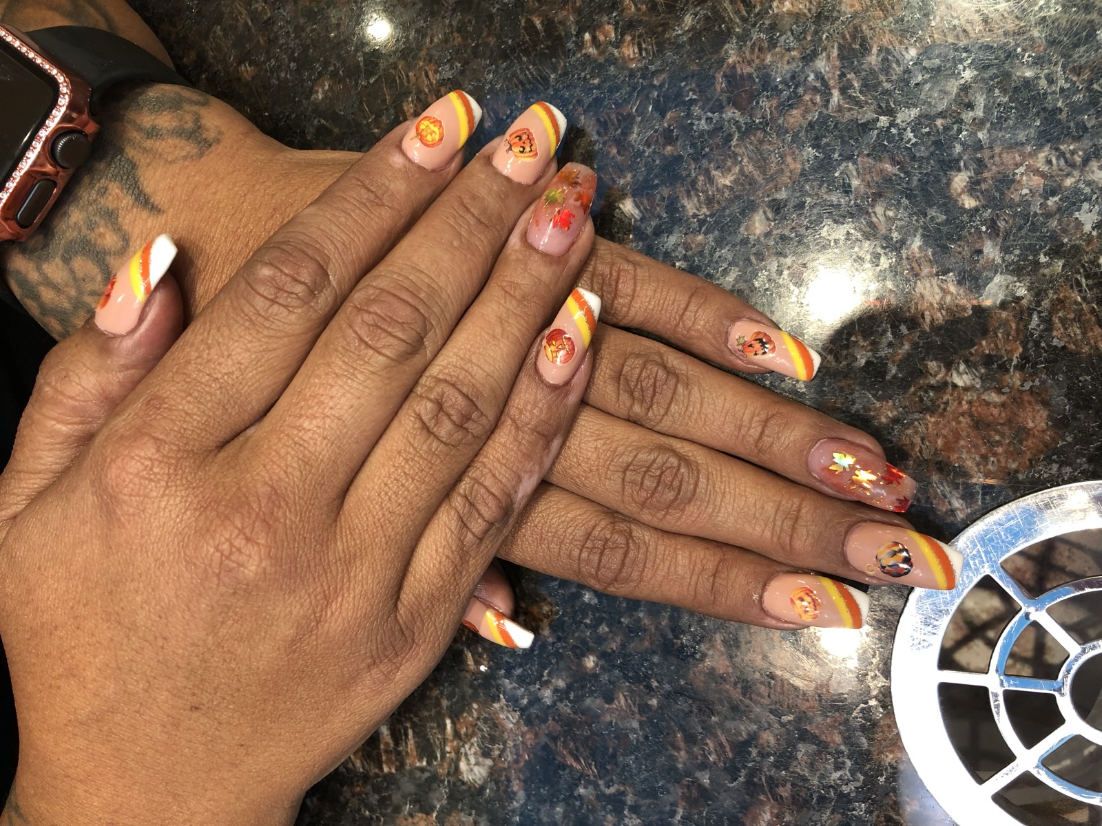 Square nails with diagonal fall stripes, pumpkin accents, and leaf sequins